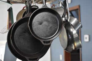 cast-iron-cookware hanging on a kitchen rack
