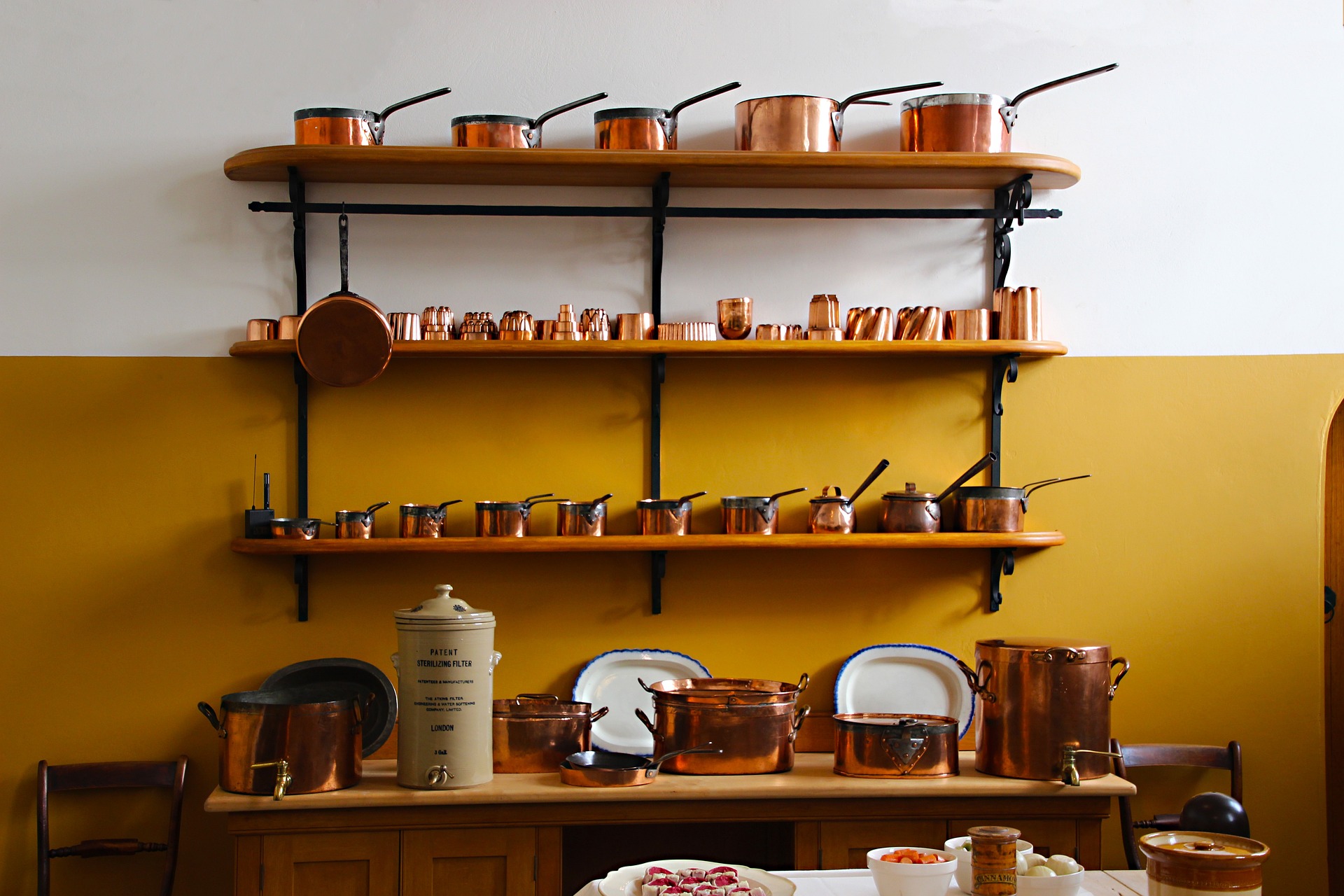 Multiple shelves with copper cookware